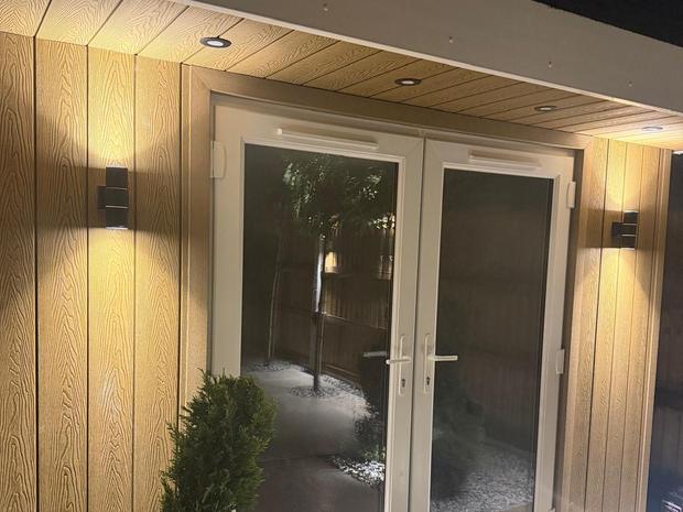 Cedar effect cladding with wall lights and soffit downlighters